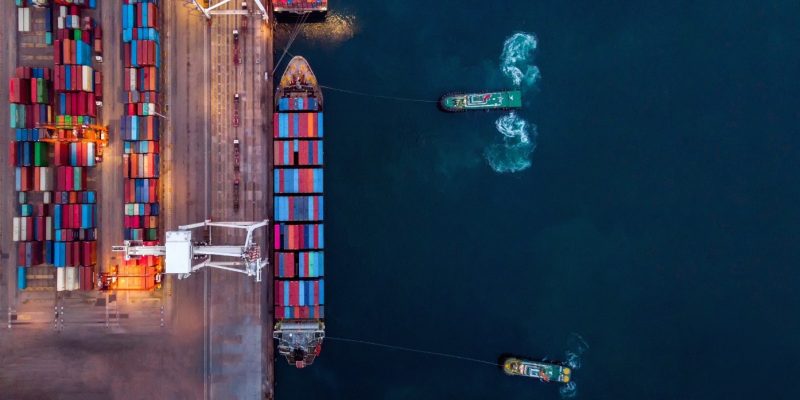 cargo-container-ship-with-tug-boat-are-working-dra-2026-01-07-02-06-19-utc (1)